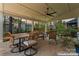 Inviting outdoor patio with a dining area, comfortable seating, and a ceiling fan for relaxing and entertaining at 10072 Fox Trotter Ln, Midland, NC 28107