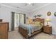 Bedroom with neutral carpet, a ceiling fan, and a wooden headboard bed beneath a window at 1013 Laparc Ln, Indian Trail, NC 28079
