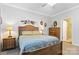 Bedroom with neutral carpet, a ceiling fan, and a wooden headboard bed beneath a window at 1013 Laparc Ln, Indian Trail, NC 28079