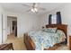 Cozy bedroom featuring a ceiling fan, a floral patterned bedspread, and natural light from a window at 1013 Laparc Ln, Indian Trail, NC 28079