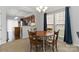 Charming dining area featuring a round table, chandelier lighting, and a seamless connection to the kitchen at 1013 Laparc Ln, Indian Trail, NC 28079