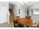 Dining area with a wooden table, chairs, a staircase, and neutral walls at 1013 Laparc Ln, Indian Trail, NC 28079