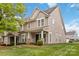 Charming townhome featuring manicured lawn, covered porch, and neutral siding, perfect for comfortable living at 1013 Laparc Ln, Indian Trail, NC 28079