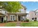 Charming townhome featuring a covered porch, neutral siding, and well-maintained landscaping at 1013 Laparc Ln, Indian Trail, NC 28079