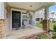 Inviting front porch with welcome decor and seating, enhancing curb appeal and offering a cozy entrance at 1013 Laparc Ln, Indian Trail, NC 28079