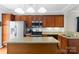 Well-equipped kitchen featuring stainless steel appliances, wood cabinetry, and a functional center island at 1013 Laparc Ln, Indian Trail, NC 28079