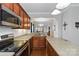 Well-lit kitchen featuring stainless steel appliances, wood cabinets, and tile flooring at 1013 Laparc Ln, Indian Trail, NC 28079