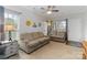Bright living room with neutral walls, plush carpeting, and ample natural light, perfect for relaxation at 1013 Laparc Ln, Indian Trail, NC 28079