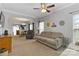 Open-concept living room with neutral walls, plush carpeting, and seamless flow into the dining area at 1013 Laparc Ln, Indian Trail, NC 28079