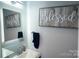 Bathroom vanity with a mirror, and a sign with the word 