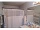 A cozy bathroom featuring a shower with a white curtain and a vanity with basic essentials at 10202 Orchard Grass Ct, Charlotte, NC 28278