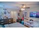 Comfortable bedroom with neutral walls, ceiling fan, dresser, TV, and crib, creating a cozy space at 10202 Orchard Grass Ct, Charlotte, NC 28278