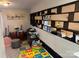 Versatile bonus room with built-in shelving, play area, and musical instruments at 10202 Orchard Grass Ct, Charlotte, NC 28278