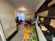 Spacious bonus room with alphabet floor tiles, musical instruments, and built-in shelving at 10202 Orchard Grass Ct, Charlotte, NC 28278