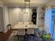 Cozy dining room with sleek modern lighting and convenient access to the outdoor space at 10202 Orchard Grass Ct, Charlotte, NC 28278