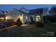 Charming two-story home with attached garage and welcoming front yard at night at 10202 Orchard Grass Ct, Charlotte, NC 28278