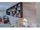 Hallway featuring a decorative shelf overlooking stairs and a cozy living room area at 10202 Orchard Grass Ct, Charlotte, NC 28278