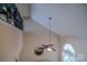 Hallway featuring a unique ceiling fan and a decorative mirror overlooking the living room at 10202 Orchard Grass Ct, Charlotte, NC 28278