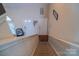 View of carpeted stairs with a landing and two white doors in the hallway at 10202 Orchard Grass Ct, Charlotte, NC 28278