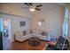 Comfortable living room with hardwood floors, ceiling fan and a view into the adjacent kitchen at 10202 Orchard Grass Ct, Charlotte, NC 28278