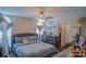 Cozy main bedroom with ceiling fan, an arched window and a walk-in closet at 10202 Orchard Grass Ct, Charlotte, NC 28278