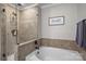 Nicely tiled bathroom featuring tub, shower and glass door at 1033 Southwest Dr, Davidson, NC 28036
