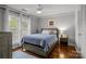 Cozy bedroom with natural light, stylish hardwood floors, a ceiling fan, and a decorative gallery wall at 1033 Southwest Dr, Davidson, NC 28036