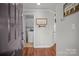 Welcoming entryway with hardwood floors leading to a laundry room with white cabinets at 1033 Southwest Dr, Davidson, NC 28036