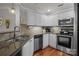 Bright kitchen with stainless steel appliances, including range, microwave, and dishwasher, and hardwood flooring at 1033 Southwest Dr, Davidson, NC 28036