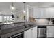 Well-lit kitchen featuring stainless steel appliances, granite countertops, tile backsplash and a view into the living area at 1033 Southwest Dr, Davidson, NC 28036