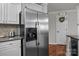 Kitchen with stainless steel refrigerator, granite countertops, hardwood floors and pantry at 1033 Southwest Dr, Davidson, NC 28036