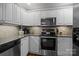 This bright kitchen features stainless steel appliances, granite counters and tile backsplash at 1033 Southwest Dr, Davidson, NC 28036