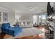 Bright living room featuring hardwood floors, a fireplace, and sliding doors to a porch at 1033 Southwest Dr, Davidson, NC 28036