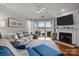 Open living room with hardwood floors, fireplace, and sliding doors to a lake-view porch at 1033 Southwest Dr, Davidson, NC 28036