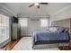 The main bedroom features a ceiling fan, hardwood flooring and a view of the backyard at 1033 Southwest Dr, Davidson, NC 28036