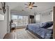 This cozy main bedroom features a ceiling fan, large windows and hardwood flooring at 1033 Southwest Dr, Davidson, NC 28036