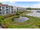 Scenic waterfront community featuring a pond, dock, and lush landscaping, offering serene lakeside living at 1033 Southwest Dr, Davidson, NC 28036