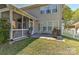 Backyard with screened porch, patio with grill, and well-maintained lawn and landscaping at 1037 Hammond Dr, Matthews, NC 28104