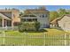 Backyard featuring manicured lawn, privacy hedge, and fenced perimeter at 1037 Hammond Dr, Matthews, NC 28104
