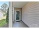 Inviting covered porch with a glass front door leading into the home at 1037 Hammond Dr, Matthews, NC 28104
