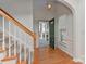 Inviting foyer with wood floors and staircase leads to a bright, open layout, creating a warm welcome at 1037 Hammond Dr, Matthews, NC 28104