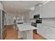 Modern kitchen with stainless steel appliances, white cabinets, and marble countertops provides a stylish cooking space at 1037 Hammond Dr, Matthews, NC 28104