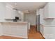 Modern kitchen featuring white cabinets, stainless steel appliances, and hardwood floors at 1037 Hammond Dr, Matthews, NC 28104