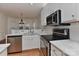 Bright kitchen with stainless steel appliances, white cabinets, and marble countertops overlooks the breakfast area at 1037 Hammond Dr, Matthews, NC 28104