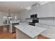 Bright kitchen with stainless steel appliances, white cabinets, and marble countertops overlooks the breakfast area at 1037 Hammond Dr, Matthews, NC 28104