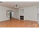 Inviting living area with hardwood floors, fireplace, and staircase leading to the front door at 1037 Hammond Dr, Matthews, NC 28104