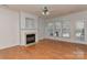Sunlit living room with hardwood floors, fireplace, and multiple windows for a bright and inviting atmosphere at 1037 Hammond Dr, Matthews, NC 28104