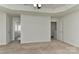Spacious main bedroom boasts neutral decor, tray ceiling, and en suite bathroom access at 1037 Hammond Dr, Matthews, NC 28104