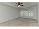 Spacious main bedroom boasts a tray ceiling, ceiling fan, and abundant natural light at 1037 Hammond Dr, Matthews, NC 28104