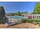 Community pool area features ample seating, a water slide, and a pergola for relaxation at 1037 Hammond Dr, Matthews, NC 28104